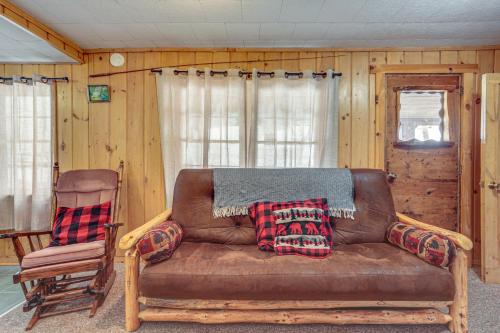 a living room with a couch and a chair at South Twin Lake Cabin with Seasonal Dock and Slip! in Conover