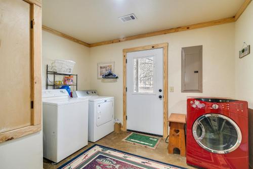 a laundry room with a red washing machine in it at Boat Launch On-Site Lakefront Toledo Bend Getaway in Many