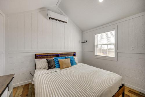 a bedroom with a bed in a room with a window at Hike, Hunt and Fish Pet-Friendly Studio in Dilley! in Dilley