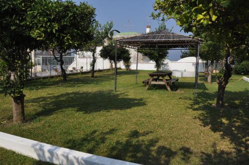 a picnic table under a gazebo in a park at Hotel Savoia in Procida