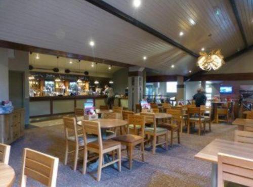 a restaurant with tables and chairs and a bar at Lakeview Lodge Whitecross bay in Troutbeck Bridge
