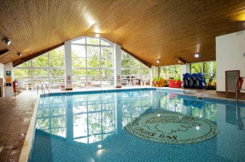 a large swimming pool in a building at Lakeview Lodge Whitecross bay in Troutbeck Bridge