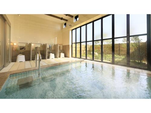 a large swimming pool in a house with windows at Hotel Futaba no Mori - Vacation STAY 56187v in Kiyohashi