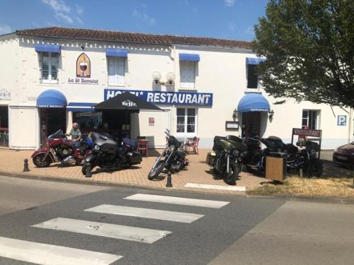 a group of motorcycles parked outside of a restaurant at Le Saint Benoist in Aizenay