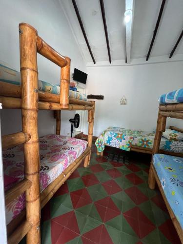 a room with two bunk beds and a tiled floor at Famihotel Asturias in Hispania