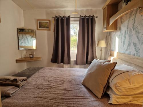 a bedroom with a large bed with a window at Eastington in Lapford