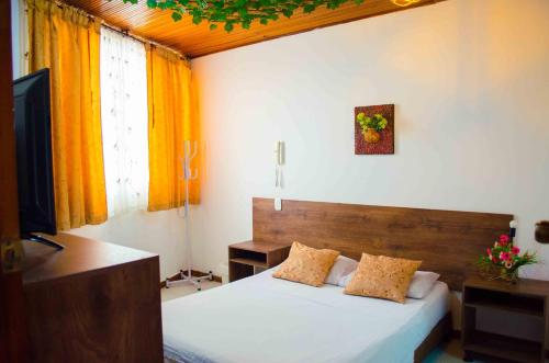 Postel nebo postele na pokoji v ubytování Hotel Elimar