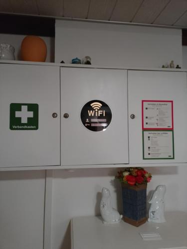 a kitchen with white cabinets with stickers on them at Privatzimmer Zur alten Salzstraße in Schnakenbek