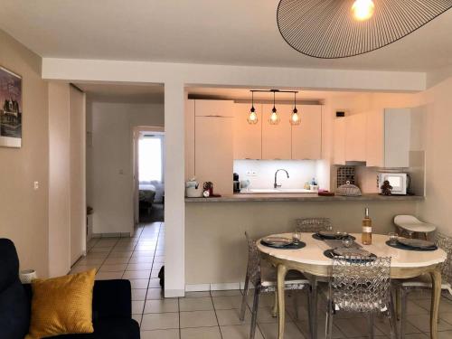 une cuisine et un salon avec une table et des chaises dans l'établissement Résidence La Lorena - LA BAULE COEUR DE VILLE MAE-2491, à La Baule