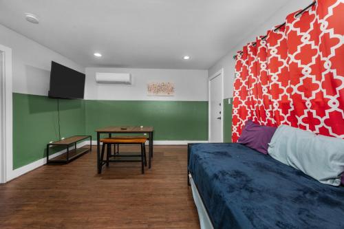 a bedroom with a bed and a table in it at Modern Quirky Apartment Near Medical Center in Houston