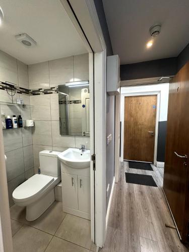 a bathroom with a toilet and a sink at Abbey Apartments in Dublin