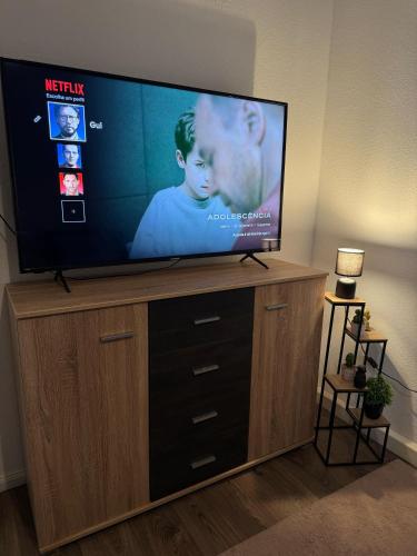 a flat screen tv sitting on top of a entertainment center at Schöne Wohnung im Herzen Jülichs in Jülich