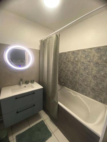 une salle de bain avec un lavabo, une baignoire et un miroir dans l'établissement Résidence Caz-66-la Baule Escoublac - LA BAULE - PROCHE PLAGE MAE-3391, à Mazy