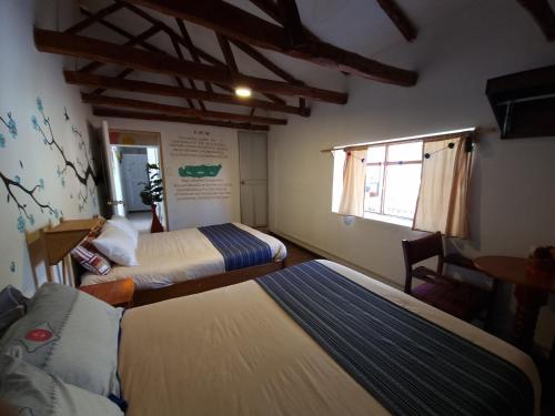 Ένα ή περισσότερα κρεβάτια σε δωμάτιο στο Valle verde, Hostel & camping