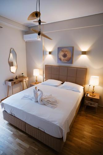 a bedroom with two swans sitting on a bed at DON Luxury Living Volos in Volos