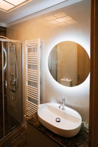 a bathroom with a sink and a mirror at DON Luxury Living Volos in Volos