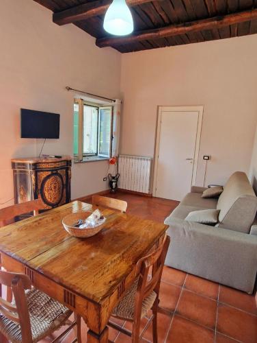 a living room with a wooden table and a couch at Home Sweet Home Galatro in Galatro
