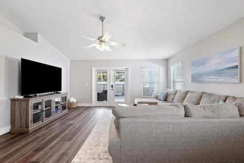 a living room with a couch and a flat screen tv at Saltwater Pool and Spa at Home in Bradenton in Bradenton