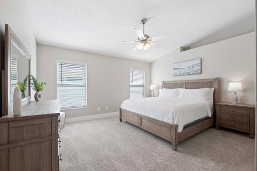 a bedroom with a bed and a ceiling fan at Saltwater Pool and Spa at Home in Bradenton in Bradenton