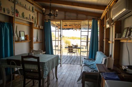 a living room with a table and a couch at Uy MÁGICA Cabaña en entorno Natural único in Mercedes
