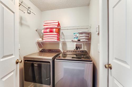 a small kitchen with a stove and some towels at Saltwater Pool and Spa at Home in Bradenton in Bradenton