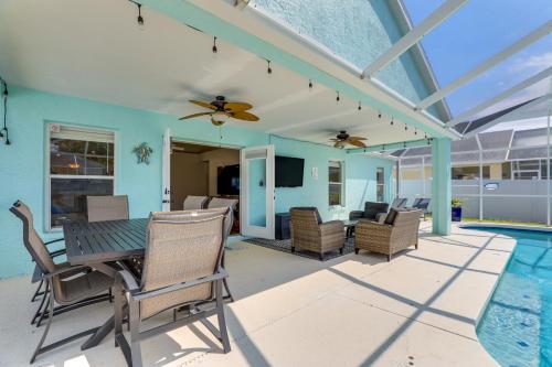 a patio with a table and chairs and a pool at Saltwater Pool and Spa at Home in Bradenton in Bradenton