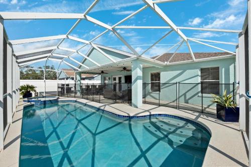 a large swimming pool with a glass roof at Saltwater Pool and Spa at Home in Bradenton in Bradenton