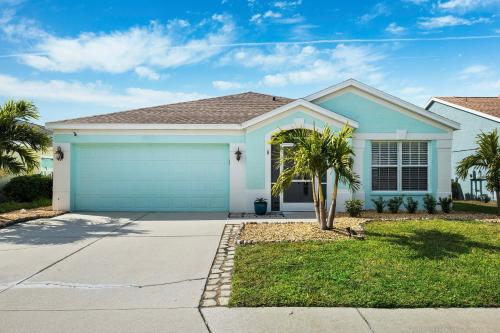 a house with a blue garage at Saltwater Pool and Spa at Home in Bradenton in Bradenton