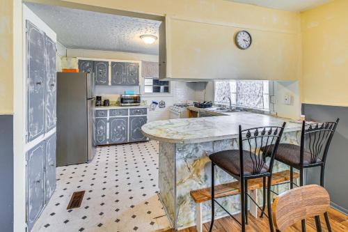 a kitchen with a counter and two chairs in it at Pet-Friendly Little Rock Home on Spacious Lot in Little Rock