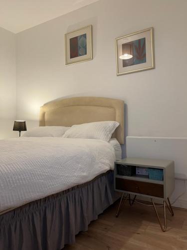 a bedroom with a large bed and a night stand at North Acton Flat in London