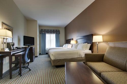 a hotel room with a bed and a desk at Holiday Inn Express Leland - Wilmington Area by IHG in Leland