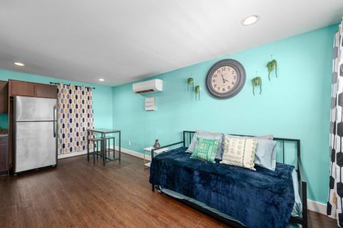 a room with a bed and a clock on the wall at Bright and Cozy Med Center Apartment in Houston