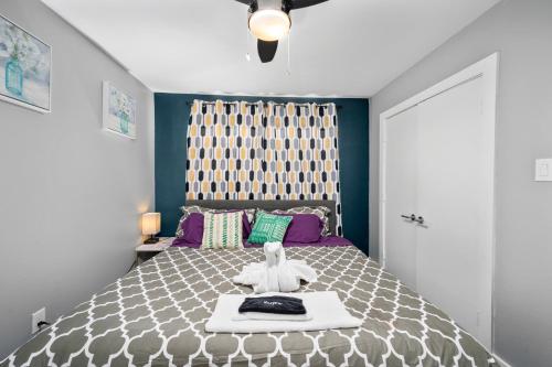 a bedroom with a bed with a teddy bear on it at Bright and Cozy Med Center Apartment in Houston