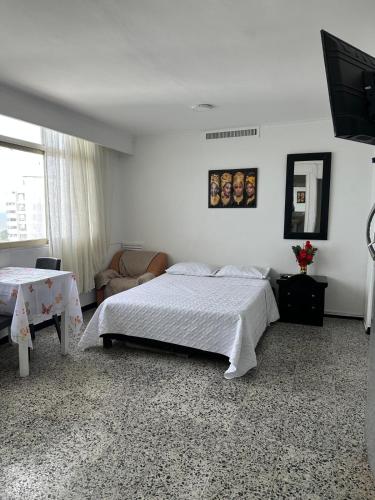 a bedroom with a bed and a television in it at Laguito Suites Cartagena in Cartagena de Indias