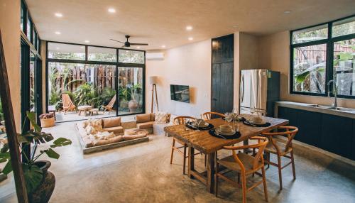 a living room with a wooden table and chairs at Round Luxury Jungle Villa Priv Pool-Concierge 4A in Tulum