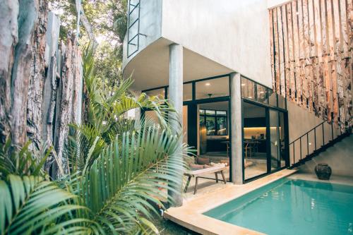 a house with a swimming pool in front of it at Round Luxury Jungle Villa Priv Pool-Concierge 4A in Tulum