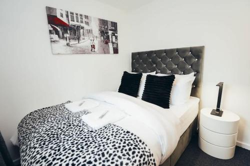 a bedroom with a black and white cheetah print bed at Snug 1BR Apt, Self Check In, Parking, By DerBnB in Hilton