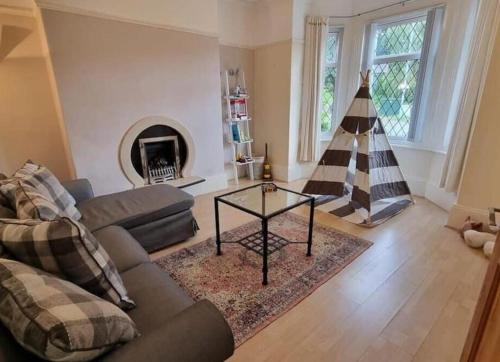 a living room with a couch and a fireplace at Near city centre sleeps 11, 4-spacious Bed rooms,2-Lounges 2-toilets 1-kitchen ideal Familys&Groups in Manchester