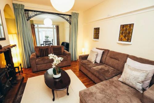 a living room with a couch and a table at Huge 4 Bed Family Home in Derbyshire with Parking in Derby