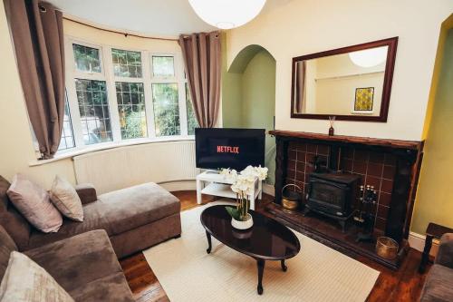 a living room with a couch and a fireplace at Huge 4 Bed Family Home in Derbyshire with Parking in Derby