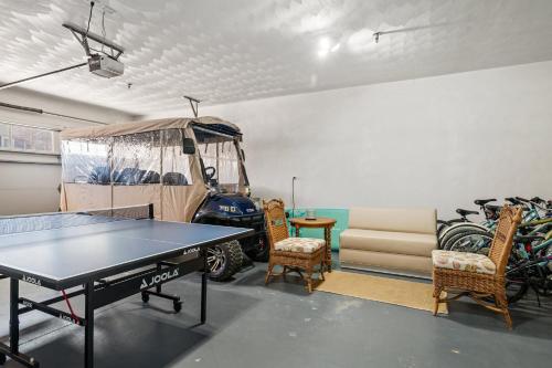 a room with a ping pong table and chairs at Golf Tennis Pool Beach - Bay Creek Caddy Shack in Cape Charles
