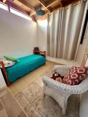 a room with a bed and a couch and a chair at Doña Patty in El Tabo