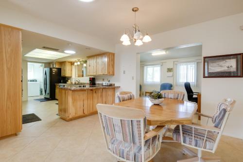 a dining room and kitchen with a wooden table and chairs at Patio and Mtn Views 55 and Apache Junction Home! in Apache Junction