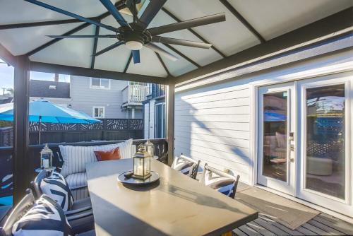 a table and chairs on a patio with a ceiling fan at Barefoot 101 One Block to Beach 2 Bed 1 Bath in Encinitas
