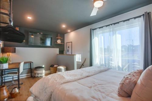 a bedroom with a large bed and a window at Barefoot 101 One Block to Beach 2 Bed 1 Bath in Encinitas