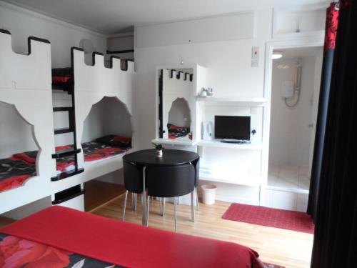 a room with a black table in a room with bunk beds at Galway Guest House in Weymouth