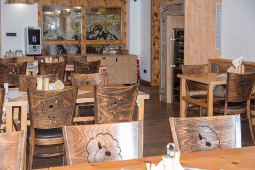 a dining room with wooden tables and chairs at Penzion Ovečka in Nýdek