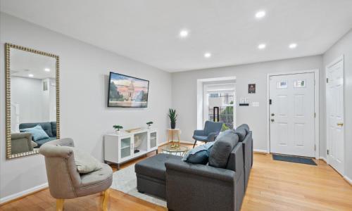 a living room with two couches and a mirror at Modern Luxury DC Free Parking in Arlington