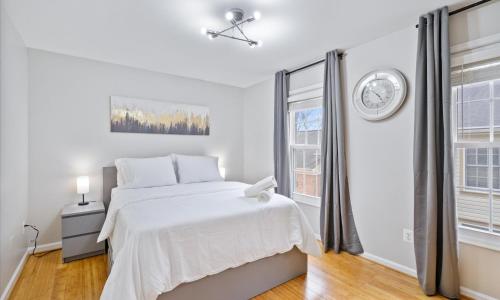 a white bedroom with a bed and a window at Modern Luxury DC Free Parking in Arlington