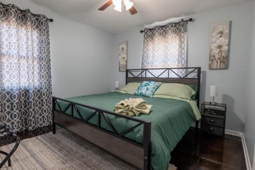 a bedroom with a bed with a green comforter at Cozy Apt Lake Park Station Airport Hospital NJ NYC in Rahway